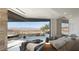 A modern main bedroom features a comfortable bed and a beautiful view of the desert landscape at 21 Rockstream Dr, Henderson, NV 89012