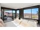 Modern main bedroom with floor to ceiling windows and a large terrace showcasing mountain views at 21 Rockstream Dr, Henderson, NV 89012