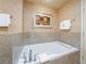 Bathroom with a bathtub and neutral tones, including a painting on the wall at 211 E Flamingo Rd # 1011, Las Vegas, NV 89169