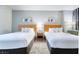 Clean bedroom view showing two beds and a bedside table in between at 211 E Flamingo Rd # 1011, Las Vegas, NV 89169