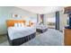 Spacious bedroom featuring two beds, cityscape views, and stylish decor at 211 E Flamingo Rd # 1011, Las Vegas, NV 89169