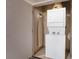Laundry area featuring stacked washer/dryer, ironing board, and storage at 211 E Flamingo Rd # 1011, Las Vegas, NV 89169