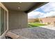 Spacious backyard with brick-paved patio, artificial turf, and desert landscaping, perfect for outdoor living at 2114 Cold Canyon Ave, North Las Vegas, NV 89086