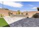 Secluded backyard features a brick-paved patio, bench, and desert landscaping, offering a private outdoor space at 2114 Cold Canyon Ave, North Las Vegas, NV 89086