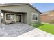 Relaxing backyard boasts a covered patio, minimal synthetic lawn and decorative pavers, perfect for outdoor enjoyment at 2114 Cold Canyon Ave, North Las Vegas, NV 89086