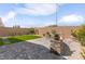 Serene backyard showcasing a paved patio, lush artificial grass, and mature landscaping at 2114 Cold Canyon Ave, North Las Vegas, NV 89086