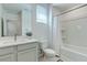 Well-lit bathroom featuring a single sink vanity and a shower-tub combination with a white curtain at 2114 Cold Canyon Ave, North Las Vegas, NV 89086