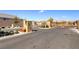Gated entrance to the community with stone pillars, desert landscaping, and security features at 2114 Cold Canyon Ave, North Las Vegas, NV 89086