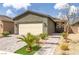 Charming home featuring a desert landscaped front yard, paver driveway and walkway, and appealing curb appeal at 2114 Cold Canyon Ave, North Las Vegas, NV 89086