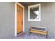 Charming front porch features a bench, decorative wreath, and ample natural light creating a welcoming entrance at 2114 Cold Canyon Ave, North Las Vegas, NV 89086
