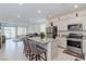 Open kitchen view featuring bar stool seating, stainless steel appliances, and seamless connection to the living area at 2114 Cold Canyon Ave, North Las Vegas, NV 89086