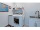 Functional laundry room featuring a modern washer and dryer, ample storage, and a utility sink at 2114 Cold Canyon Ave, North Las Vegas, NV 89086