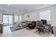 Inviting living room with lots of natural light, tile floors, comfortable seating, and sliding glass doors to the backyard at 2114 Cold Canyon Ave, North Las Vegas, NV 89086