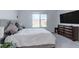 Comfortable bedroom features a plush bed, carpeted floors, and a large window for natural light and scenic views at 2114 Cold Canyon Ave, North Las Vegas, NV 89086