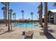 A community pool with lounge chairs and palm trees offers a resort-like setting for relaxation and recreation at 2114 Cold Canyon Ave, North Las Vegas, NV 89086