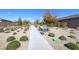 Picturesque walking path lined with lush landscaping and seating, perfect for leisurely strolls at 2114 Cold Canyon Ave, North Las Vegas, NV 89086