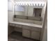 Bathroom vanity with bright lighting, storage cabinets, and a large mirror at 212 Bradshaw Way, Las Vegas, NV 89145