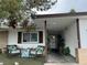 Charming home exterior with a cozy seating area and lush greenery in the front at 212 Bradshaw Way, Las Vegas, NV 89145