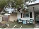Inviting front yard features a seating area with comfortable chairs and decorative pillows at 212 Bradshaw Way, Las Vegas, NV 89145