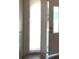 Bright hallway featuring a white door with a window pane with a hardwood floor at 212 Bradshaw Way, Las Vegas, NV 89145