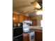 Well-lit kitchen with wood cabinets, a white range, and a ceiling fan at 212 Bradshaw Way, Las Vegas, NV 89145
