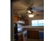 Functional kitchen with wood cabinets, a double oven, a window over the sink, and a ceiling fan at 212 Bradshaw Way, Las Vegas, NV 89145