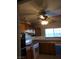 Functional kitchen with wood cabinets, a double oven, a window over the sink, and a ceiling fan at 212 Bradshaw Way, Las Vegas, NV 89145