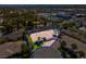 Stunning aerial view of a desert home with a pool, lush landscaping and palm trees in a desirable neighborhood at 2290 Casa Bella Ct, Las Vegas, NV 89117