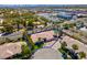 Stunning aerial view of a desert home with a pool, lush landscaping and palm trees in a desirable neighborhood at 2290 Casa Bella Ct, Las Vegas, NV 89117