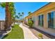 Backyard with palm trees, desert landscaping and a walkway to the patio at 2290 Casa Bella Ct, Las Vegas, NV 89117