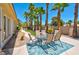 Palm tree lined backyard patio with a dining table and desert landscaping at 2290 Casa Bella Ct, Las Vegas, NV 89117