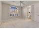 Neutral bedroom featuring an ensuite bathroom, ceiling fan and plantation shutters at 2290 Casa Bella Ct, Las Vegas, NV 89117