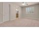 Neutral bedroom with plush carpeting, ceiling fan and a window with bright light and wood blinds at 2290 Casa Bella Ct, Las Vegas, NV 89117