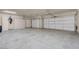 Spacious garage with two garage doors, storage cabinets and a utility door at 2290 Casa Bella Ct, Las Vegas, NV 89117