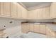 Functional laundry room featuring ample storage cabinets and a sink for added convenience at 2290 Casa Bella Ct, Las Vegas, NV 89117