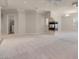 Bright, spacious living room boasts a modern fireplace, neutral carpet, and recessed lighting at 2290 Casa Bella Ct, Las Vegas, NV 89117