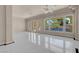 Bright living room featuring large windows, tile floors, and high ceilings at 2290 Casa Bella Ct, Las Vegas, NV 89117