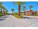 Neighborhood entrance with palm trees, mature landscaping, and a security gate at 2290 Casa Bella Ct, Las Vegas, NV 89117