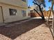 Backyard area featuring desert landscaping with stone pavers and a wood fence at 2606 Heartland Ave, Henderson, NV 89074