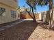 Backyard area featuring desert landscaping with stone pavers and a wood fence at 2606 Heartland Ave, Henderson, NV 89074