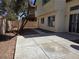 This backyard features desert landscaping, concrete slabs and a patio at 2606 Heartland Ave, Henderson, NV 89074