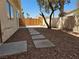 This backyard features desert landscaping, concrete slabs and new fencing at 2606 Heartland Ave, Henderson, NV 89074