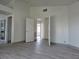 Spacious bedroom with wood-look flooring and multiple entryways at 2606 Heartland Ave, Henderson, NV 89074