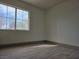 Bright, open bedroom with large window, new floors, and plenty of natural light at 2606 Heartland Ave, Henderson, NV 89074