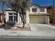 Charming two-story home featuring a tile roof, attached garage, and well-maintained landscaping at 2606 Heartland Ave, Henderson, NV 89074