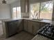 This kitchen features stone countertops, stainless steel appliances, and a window for natural lighting at 2606 Heartland Ave, Henderson, NV 89074