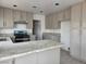 This kitchen features stone countertops, stainless steel appliances, and ample cabinetry at 2606 Heartland Ave, Henderson, NV 89074