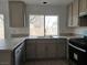 This kitchen features stone countertops, stainless steel appliances, and a window for natural lighting at 2606 Heartland Ave, Henderson, NV 89074