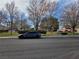 Neighborhood street view with manicured landscaping and mature trees at 2606 Heartland Ave, Henderson, NV 89074