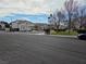 View of the street showcasing houses with well-maintained lawns and landscaping at 2606 Heartland Ave, Henderson, NV 89074